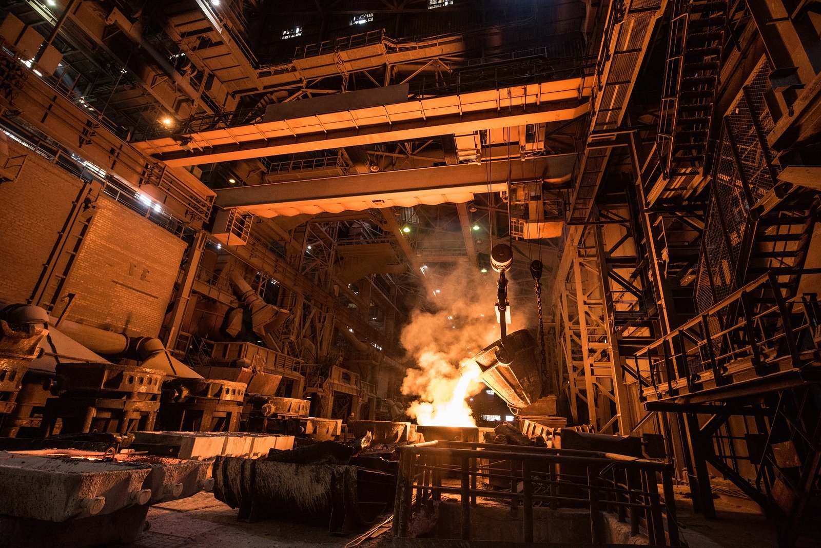 Tank pours liquid metal in the molds at the steel mill. Interior of a steel mill.