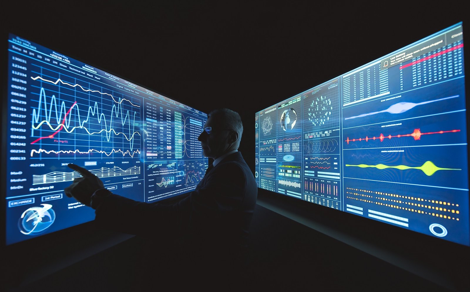 The businessman works on the blue sensor screen with graphics